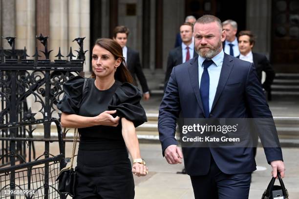 Coleen Rooney departs with husband Wayne Rooney at Royal Courts of Justice, Strand on May 12, 2022 in London, England. Coleen Rooney, wife of Derby...