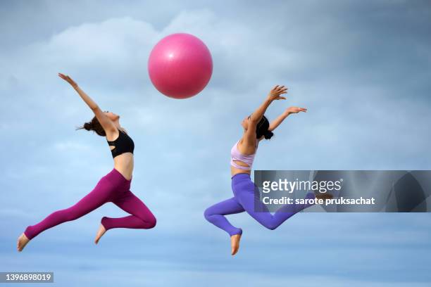 asian woman jumping with pink ball . - yoga ball work 個照片及圖片檔