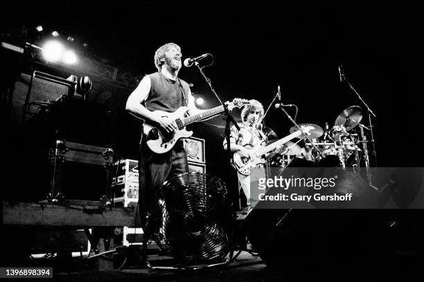 View of American Rock and Blues musicians Trey Anastasio , on guitar, and Mike Gordon, on bass, both of the group Phish, as they perform on stage at...