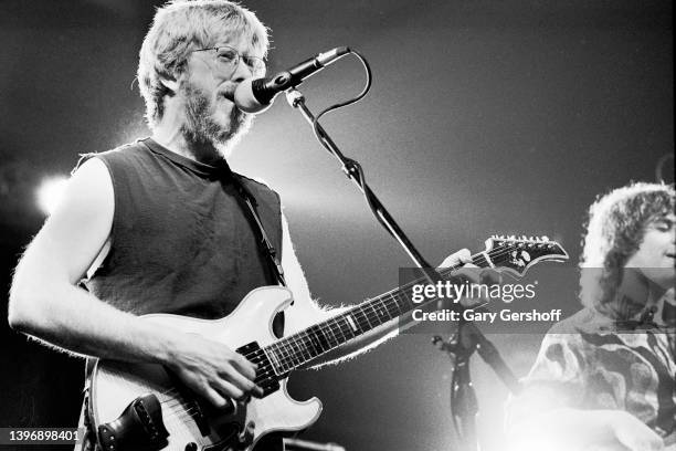 View of American Rock and Blues musicians Trey Anastasio , on guitar, and Mike Gordon , on bass, both of the group Phish, as they perform on stage at...