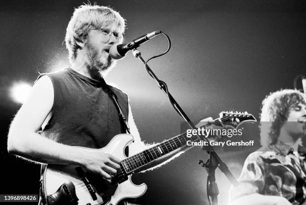 View of American Rock and Blues musicians Trey Anastasio , on guitar, and Mike Gordon , on bass, both of the group Phish, as they perform on stage at...