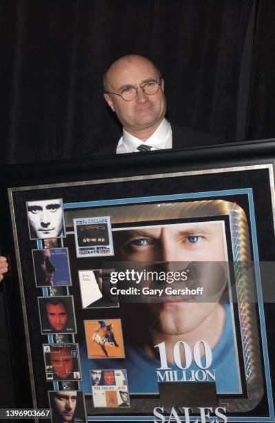 Portrait of British Pop musician Phil Collins as he poses with an award plaque during City of Hope's 'Spirit of Life' gala at Cipriani, New York, New...