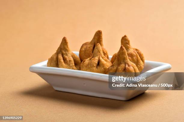 indian food modak maharashtra sweet dish on yellow background - ganesha stock pictures, royalty-free photos & images