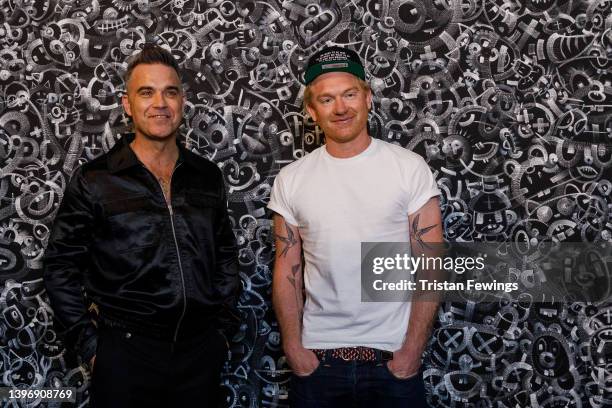 Robbie Williams and Ed Godrich attend the launch event for the Williams Godrich exhibition at Sotheby's on May 12, 2022 in London, England.