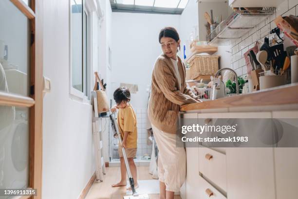 asian attractive mother teach young boy cleaning kitchen in house. - chores stock pictures, royalty-free photos & images