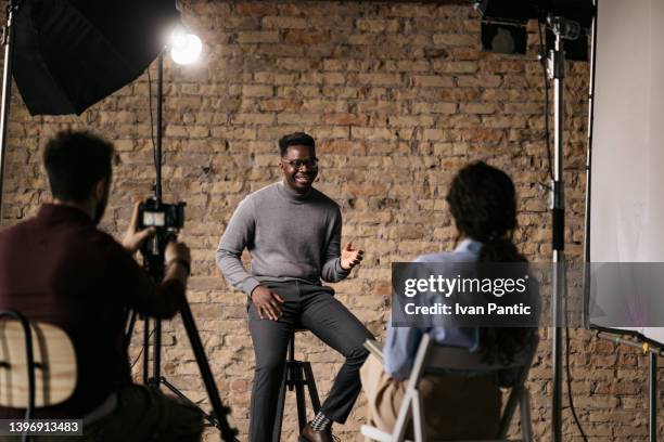 giving an interview in a modest studio - studio interview stockfoto's en -beelden