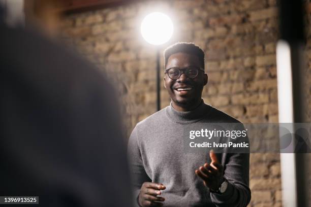 young man giving an interview in a studio - insight tv stockfoto's en -beelden