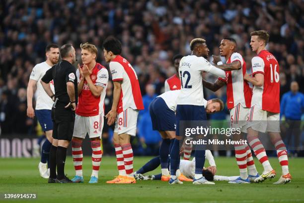 Gabriel Magalhaes of Arsenal clashes with Emerson Royal of Tottenham Hotspur before Match Referee, Paul Tierney shows a red card to Rob Holding of...