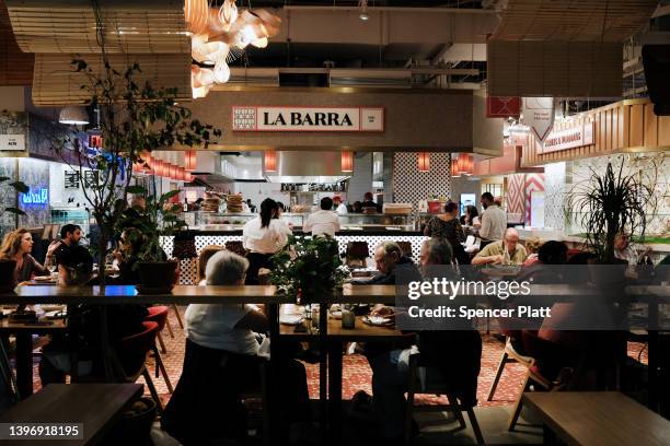 People eat at a restaurant in Hudson Yards' Spanish Market, Mercado Little Spain, on May 12, 2022 in New York City. Prices of clothing, food, gas and...