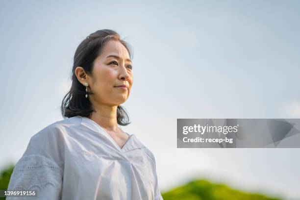 portrait of beautiful woman in nature - portrait waist up stock pictures, royalty-free photos & images