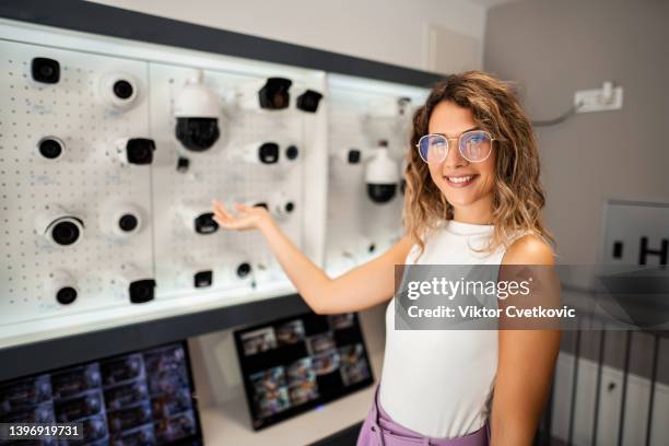 portrait of businesswoman showcasing security cameras - surveillance system stock pictures, royalty-free photos & images