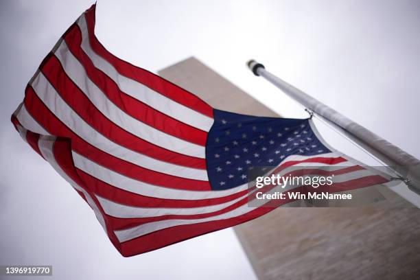 Flags at the base of the Washington Monument fly at half staff as the United States nears the 1 millionth death attributed to COVID May 12, 2022 in...