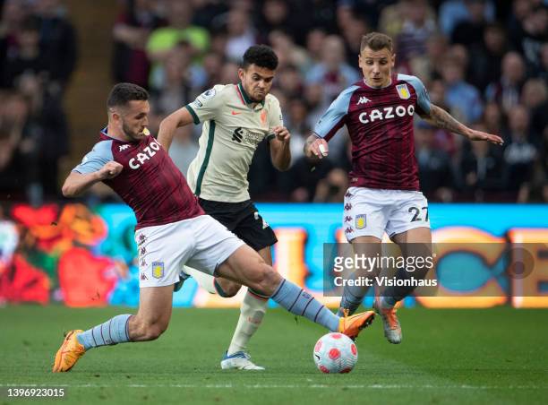 John McGinn and Lucas Digne of Aston Villa in action with Luis Diaz of Liverpool during the Premier League match between Aston Villa and Liverpool at...