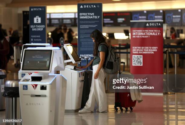 Delta Airlines customer checks in for a flight at San Francisco International Airport on May 12, 2022 in San Francisco, California. According to a...