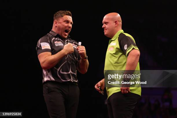 Gerwyn Price of Wales celebrates next to opponent, Michael van Gerwen of Netherlands during their match on night 14 of the Cazoo Premier League Darts...