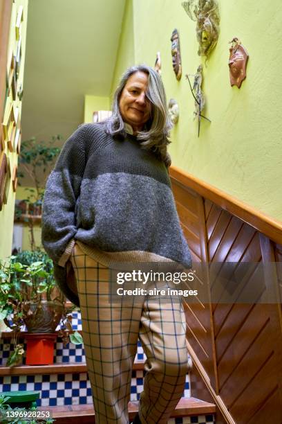 adult senior woman wearing comfortable clothes standing in staircases indoors home - plus size fashion stock pictures, royalty-free photos & images