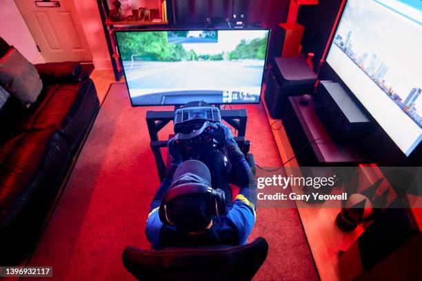 male gamer playing at night - playstation stock pictures, royalty-free photos & images