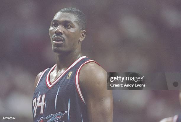 Center Hakeem Olajuwon of the Houston Rockets looks on during a game against the Orlando Magic at the Orlando Arena in Orlando, Florida. The Magic...