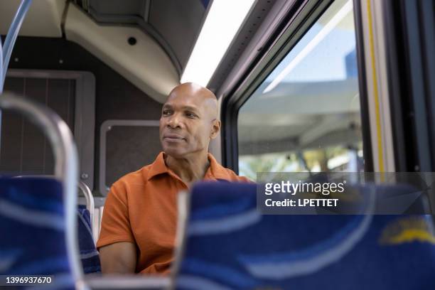 riding on the public bus - man riding bus stock pictures, royalty-free photos & images