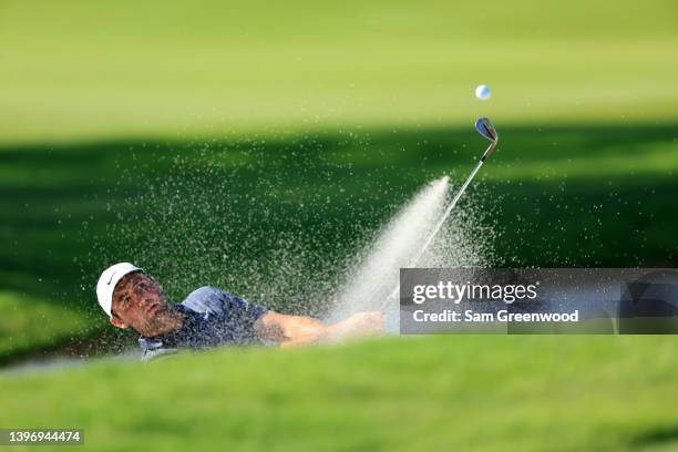 Scottie Scheffler plays a shot from a bunker on the 16th hole during the first round of the AT&T Byron Nelson at TPC Craig Ranch on May 12, 2022 in...