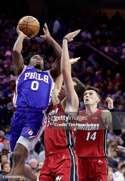 Tyrese Maxey of the Philadelphia 76ers takes a shot against Duncan Robinson and Tyler Herro of the Miami Heat in the second quarter of Game Six of...