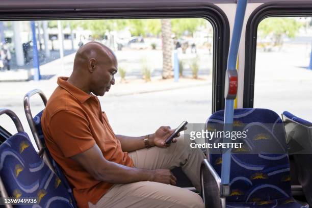 viajar en el autobús público - man riding bus fotografías e imágenes de stock