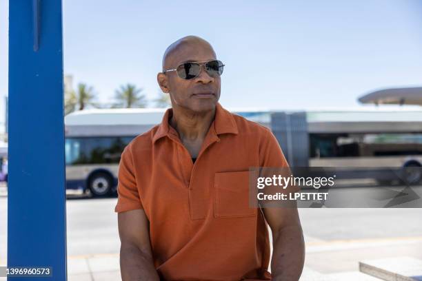 waiting at the bus station - bald man stock pictures, royalty-free photos & images