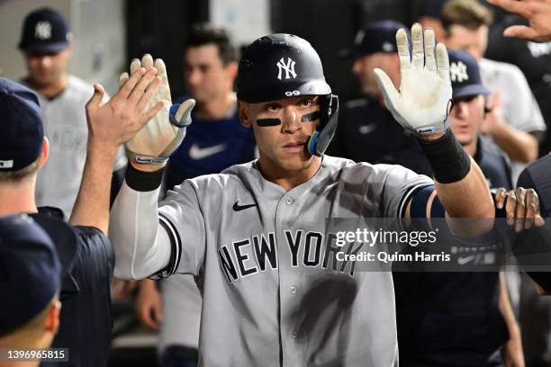 Aaron Judge of the New York Yankees celebrates in the dugout with teammates after his home run in the seventh inning against the Chicago White Sox at...