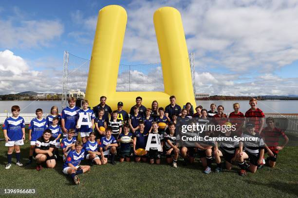 Brumbies Super Rugby players, Louise Burrows of the Wallaroos and Super W players pose with junior club rugby players during a Rugby Australia media...
