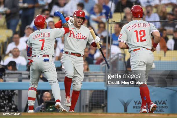 Johan Camargo of the Philadelphia Phillies celebrates his two-run home run in the second inning against the Los Angeles Dodgers with Rhys Hoskins and...