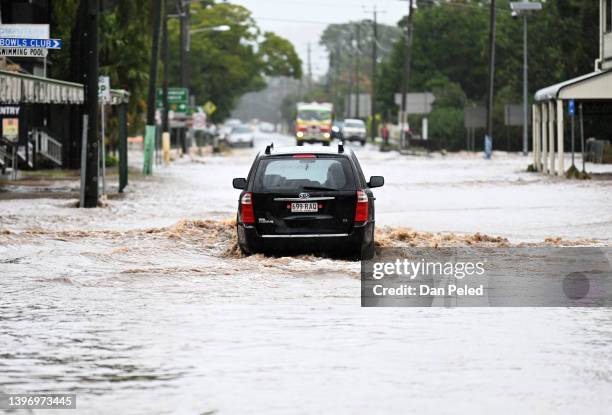 Car drives through floodwater on May 13, 2022 in Laidley, Australia. Parts of southeast Queensland are on flood watch as the state continues to...
