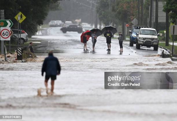 Locals inspect a road cut off by floodwater on May 13, 2022 in Laidley, Australia. Parts of southeast Queensland are on flood watch as the state...