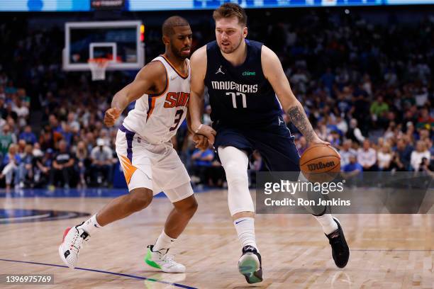 Luka Doncic of the Dallas Mavericks drives to the basket against Chris Paul of the Phoenix Suns in the fourth quarter of Game Six of the 2022 NBA...