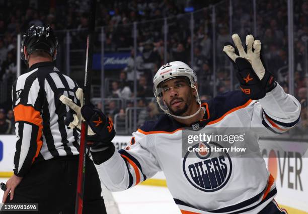 Evander Kane of the Edmonton Oilers celebrates his empty net goal behind referee Frederick L'Ecuyer during the third period in a 4-2 Oilers win in...