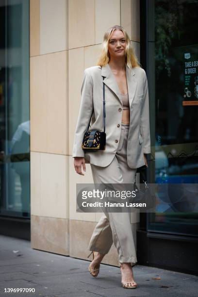 Gemma Ward wearing Henne light grey suit and Prada bag at Afterpay Australian Fashion Week 2022 on May 13, 2022 in Sydney, Australia.