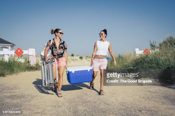 women carrying cooler at beach - choicepix stock pictures, royalty-free photos & images