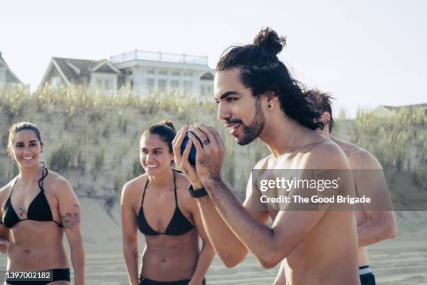 friends playing bocce ball at beach - boule stock pictures, royalty-free photos & images