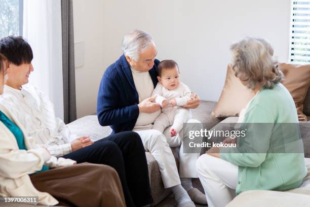 grandparents playing with their baby grandson. - association of east asian relations and japan stock pictures, royalty-free photos & images