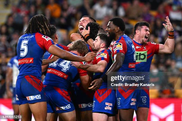 Adam Clune of the Knights celebrates with team mates after scoring a try during the round 10 NRL match between the Canterbury Bulldogs and the...