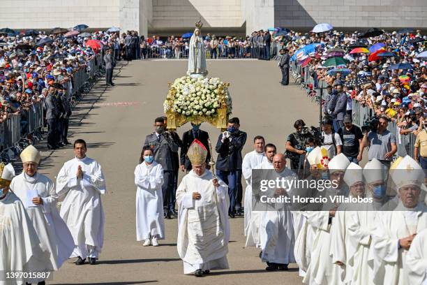 Priests precede bearers carrying the figure of Our Lady of Fátima at the farewell procession during the last day ceremonies of the two-day...