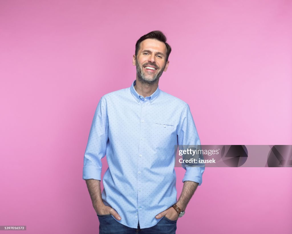 Confident man with hands in pockets