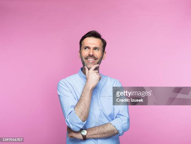 contemplative man with hand on chin - man hand on chin stock pictures, royalty-free photos & images