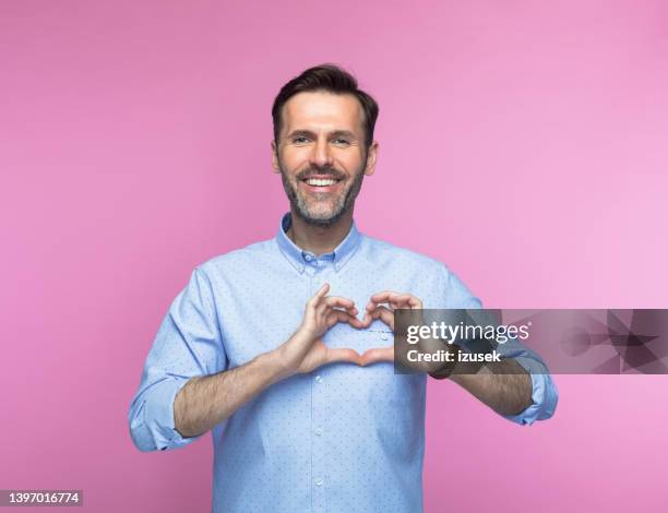 happy man gesturing heart sign - gesturing 個照片及圖片檔
