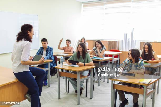 high school students on class in school listening their teacher - high school teacher stock pictures, royalty-free photos & images