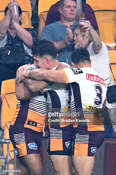 Selwyn Cobbo of the Broncos is congratulated by team mates after scoring a try during the round 10 NRL match between the Manly Sea Eagles and the...