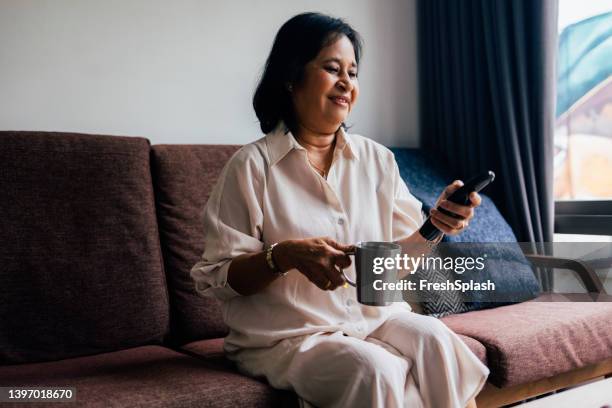 elderly woman watching tv at home - alter tv stock pictures, royalty-free photos & images