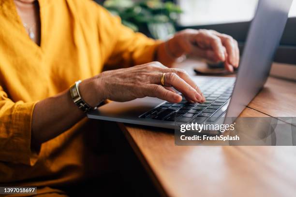 anonymous woman working from home - senior using computer stock pictures, royalty-free photos & images