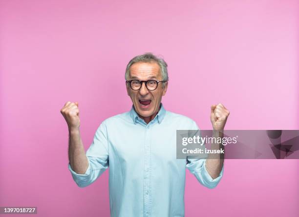 excited man shouting while gesturing with fists - sinnesrörelse bildbanksfoton och bilder