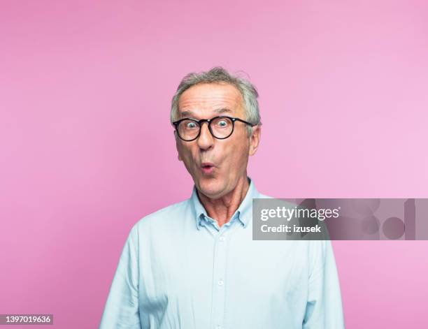 shocked retired elderly man making face - man disbelief stock pictures, royalty-free photos & images