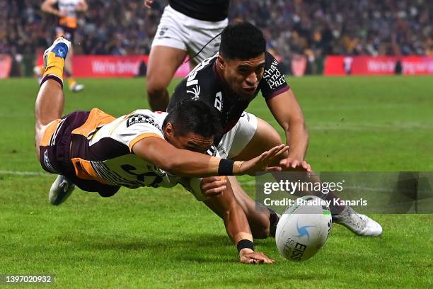 Tolutau Koula of the Sea Eagles stops Te Maire Martin of the Broncos from scoring a try during the round 10 NRL match between the Manly Sea Eagles...